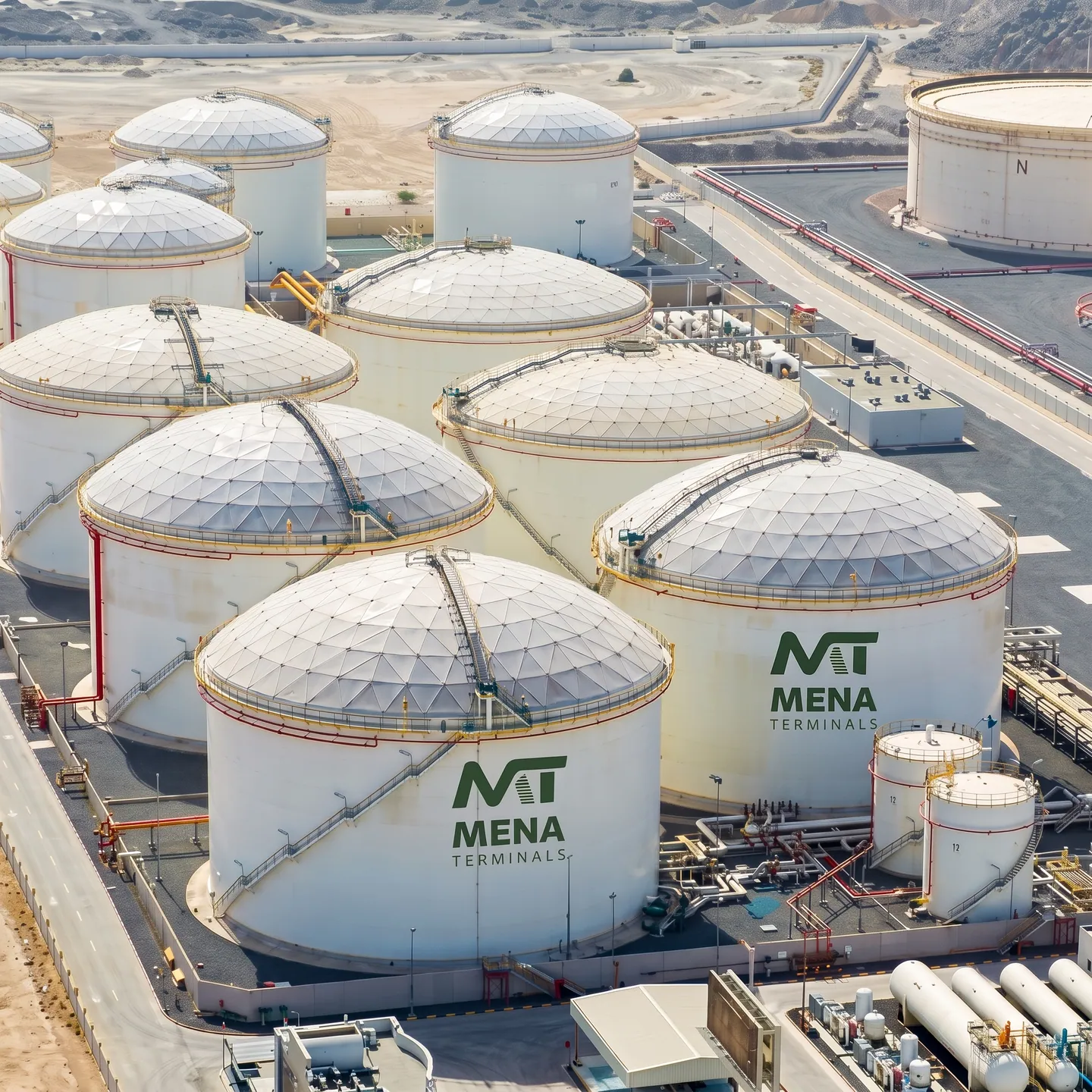 An elevated view across rows of MENA Terminals storage tanks