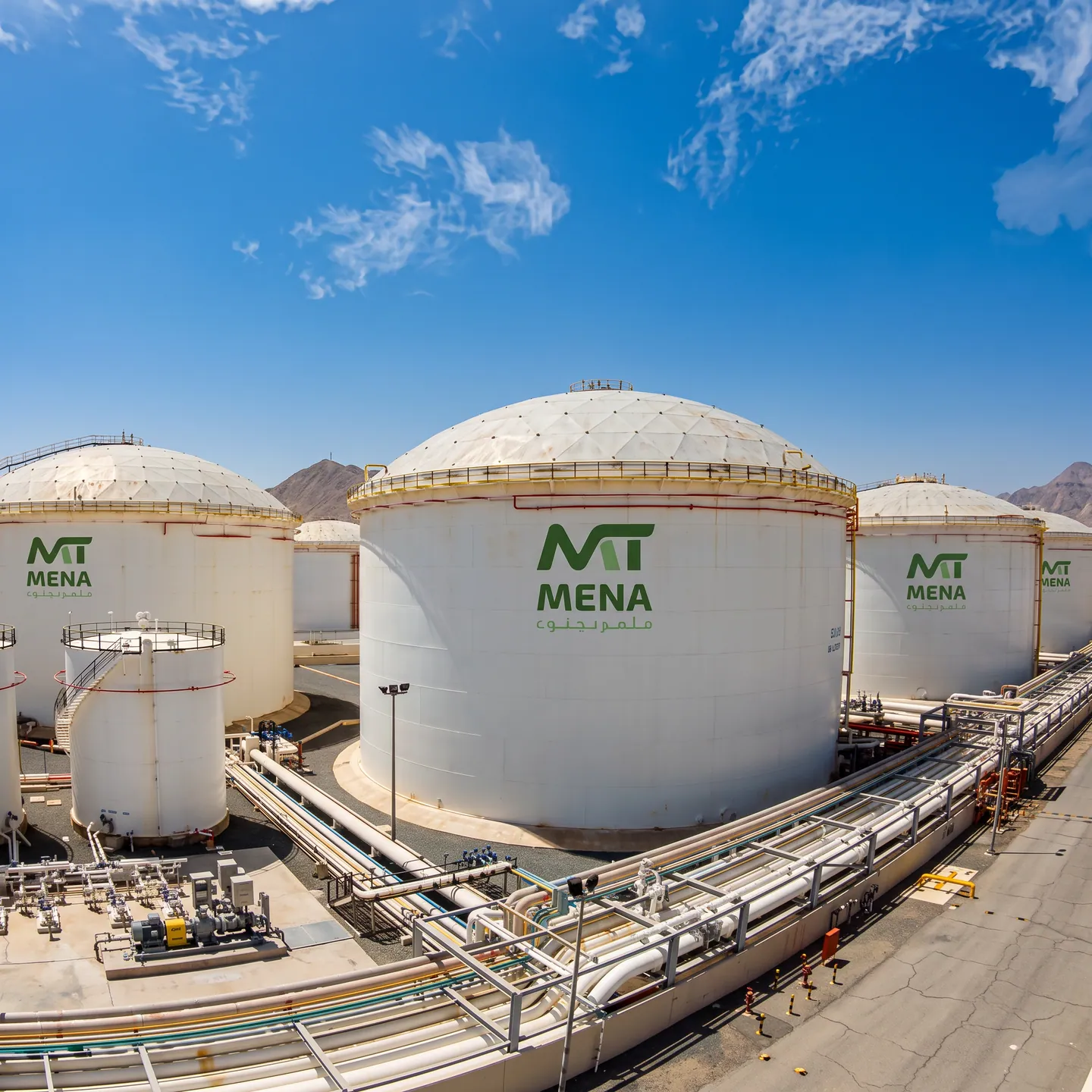 MENA Terminals storage tanks and connecting pipework under a blue sky