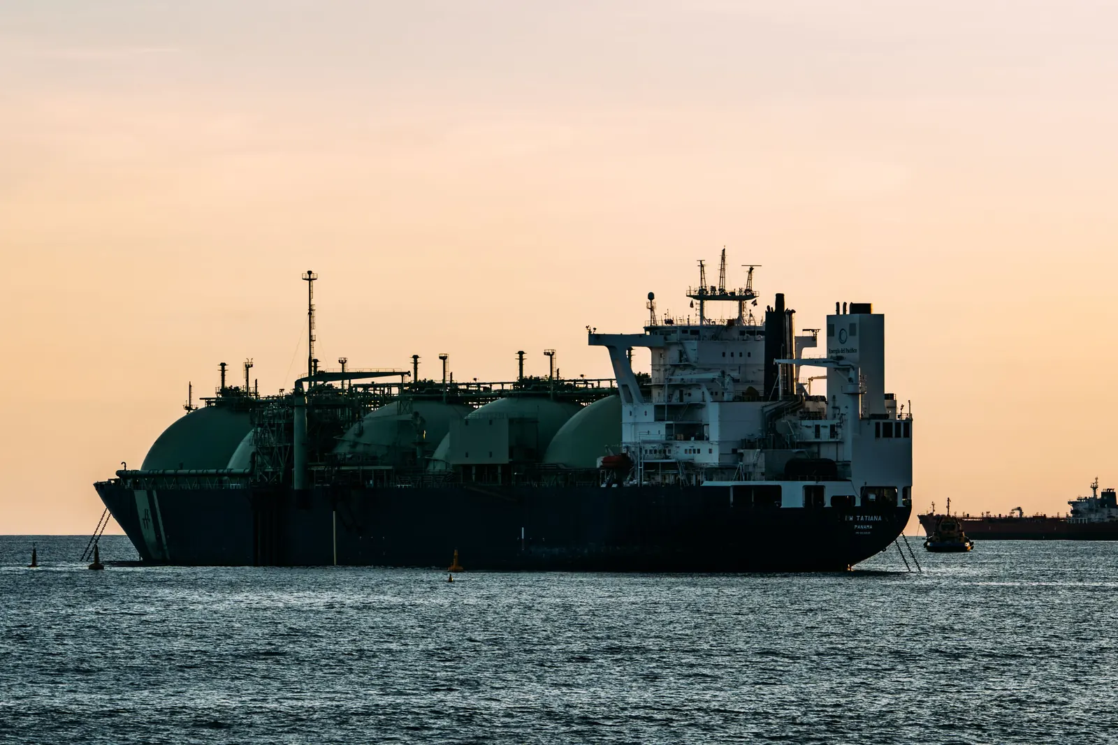 An LNG carrier at sea at sunset
