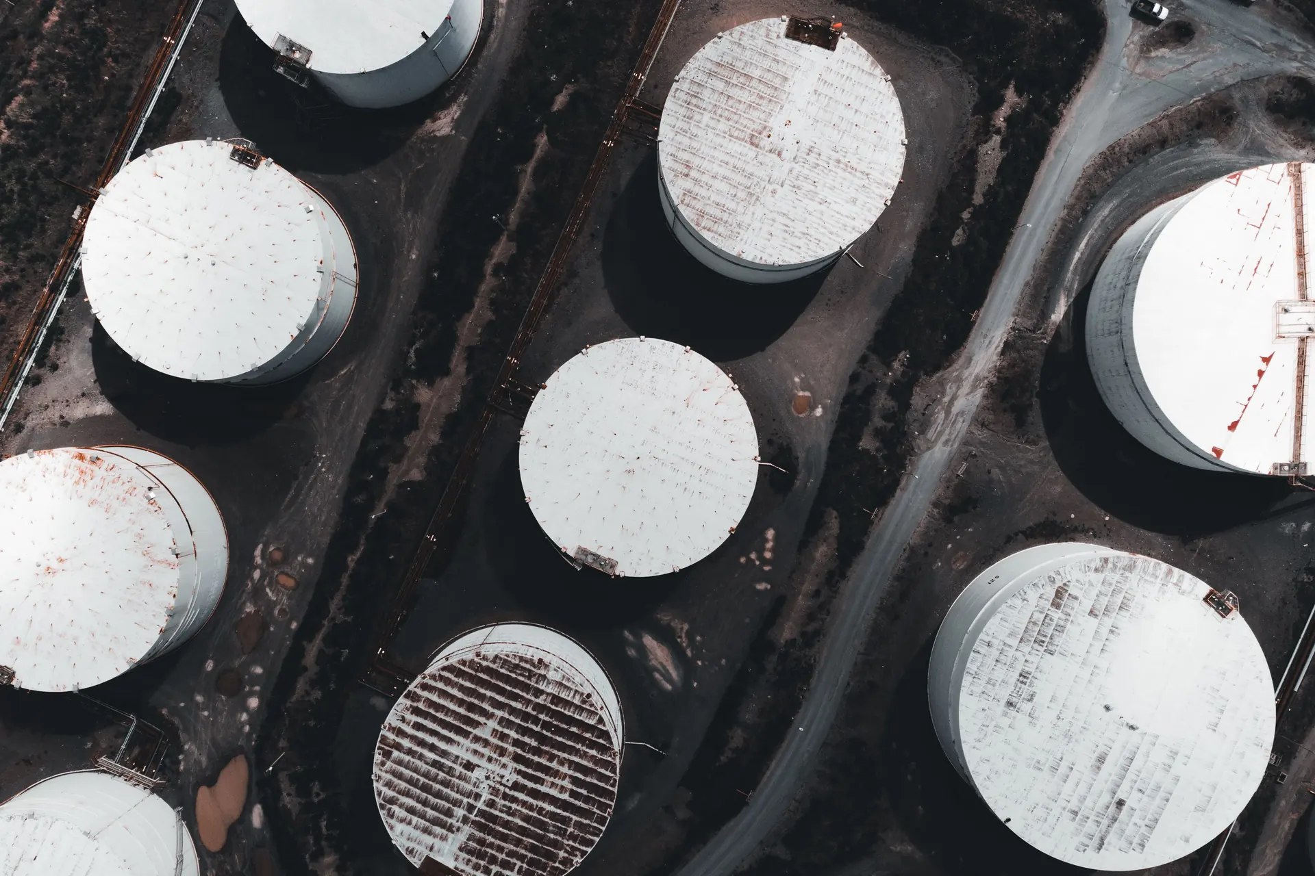 An overhead view of circular storage tanks and connecting roads