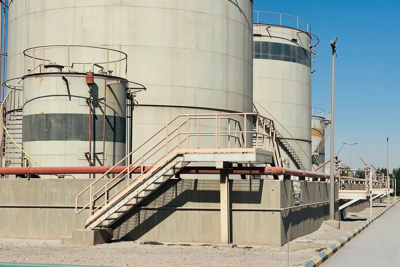 Storage tanks, pipework and access platforms at an industrial facility